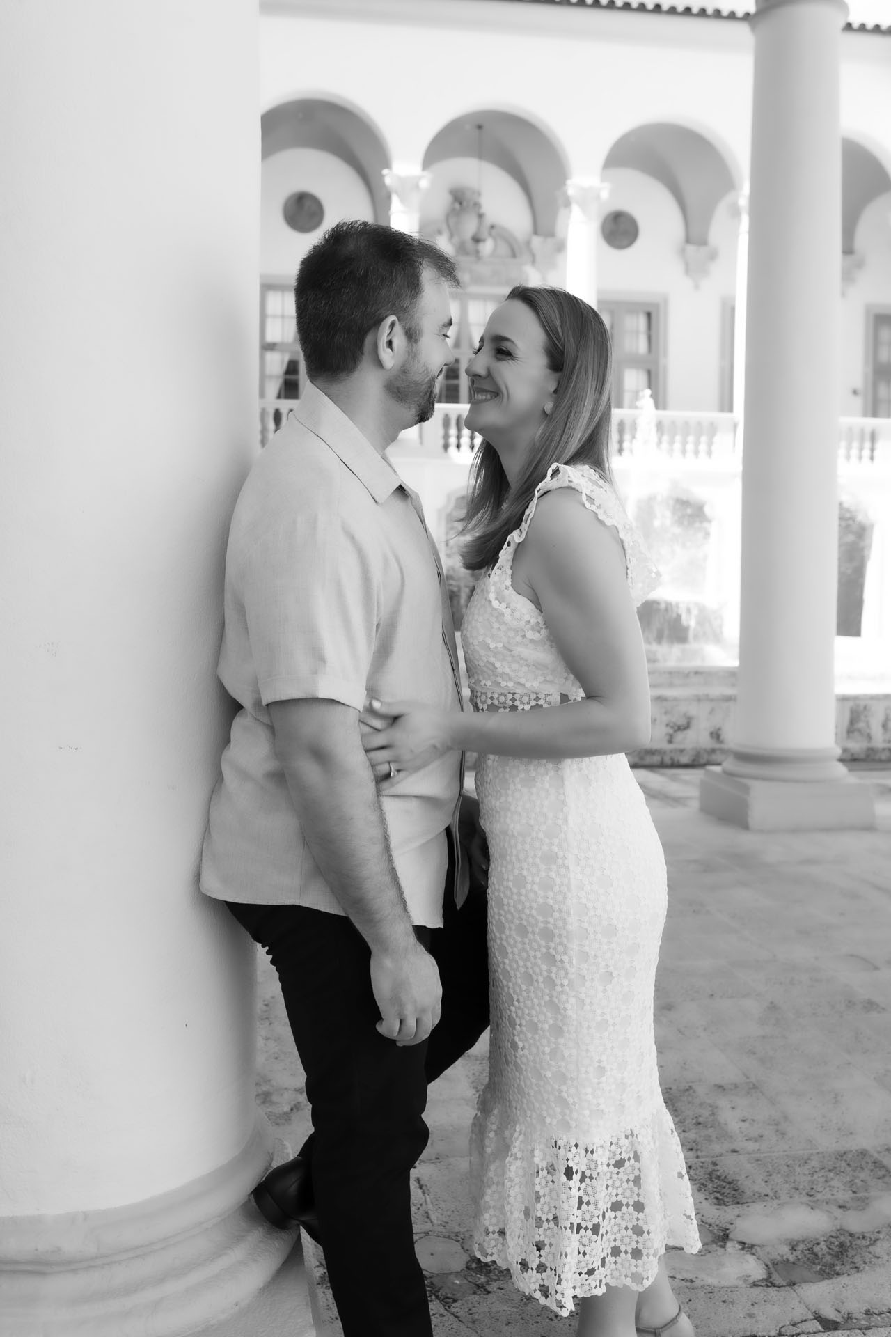Ingrid and Miguel embracing under the arches of the Biltmore