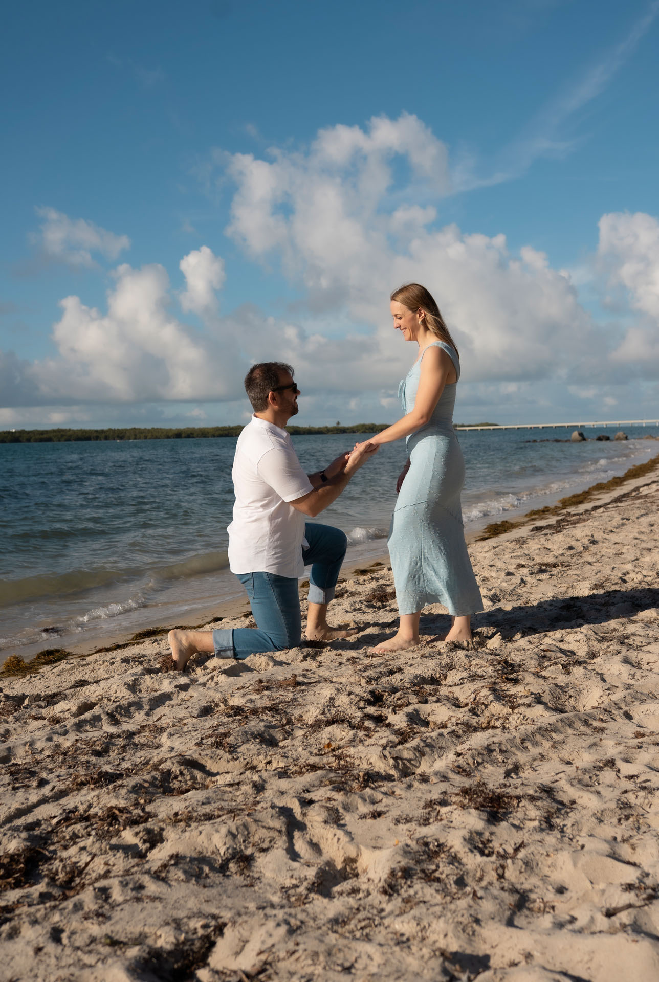 Miguel proposing to Ingrid on the beach