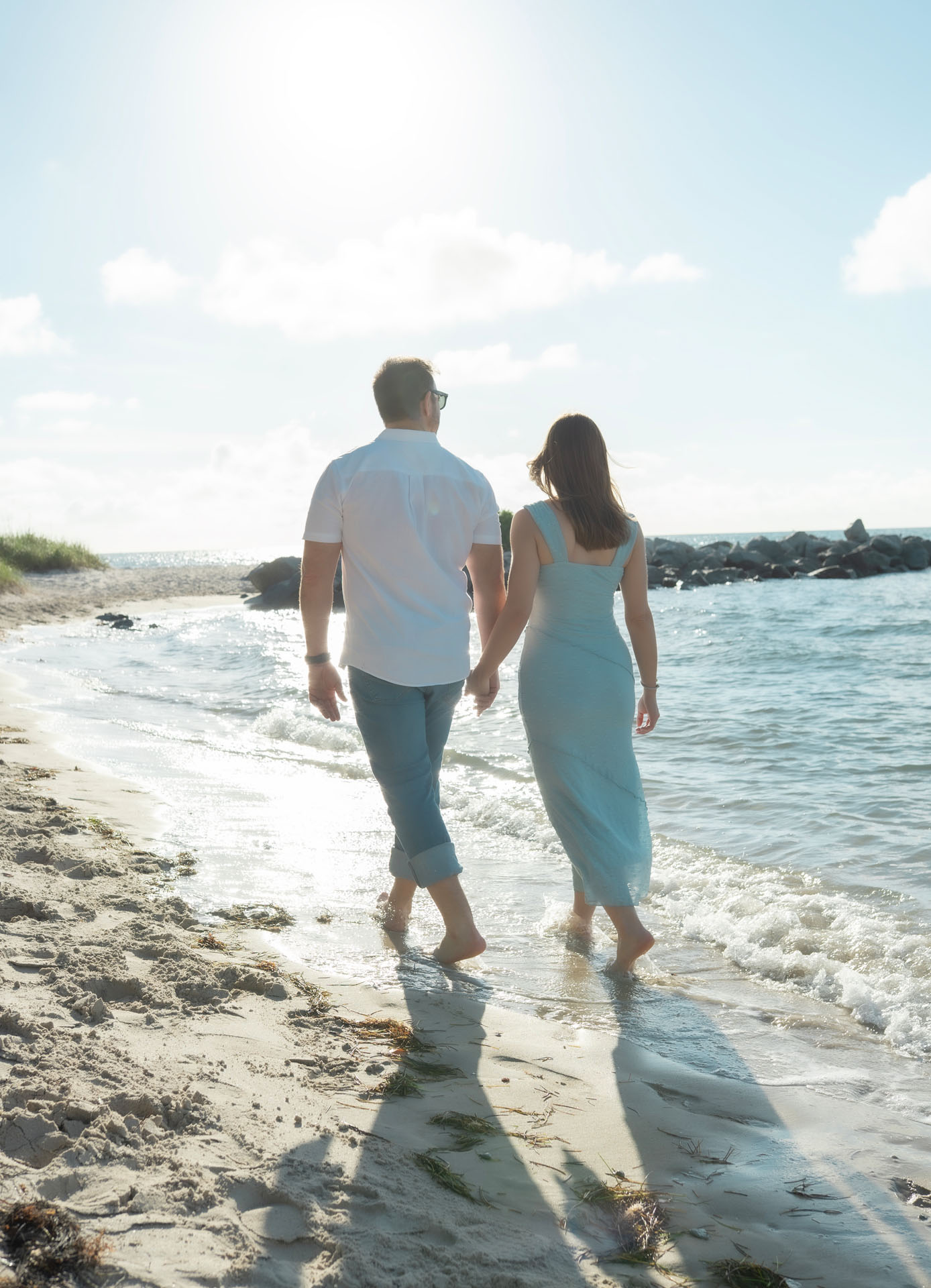 Ingrid and Miguel walking hand in hand into the sunlight