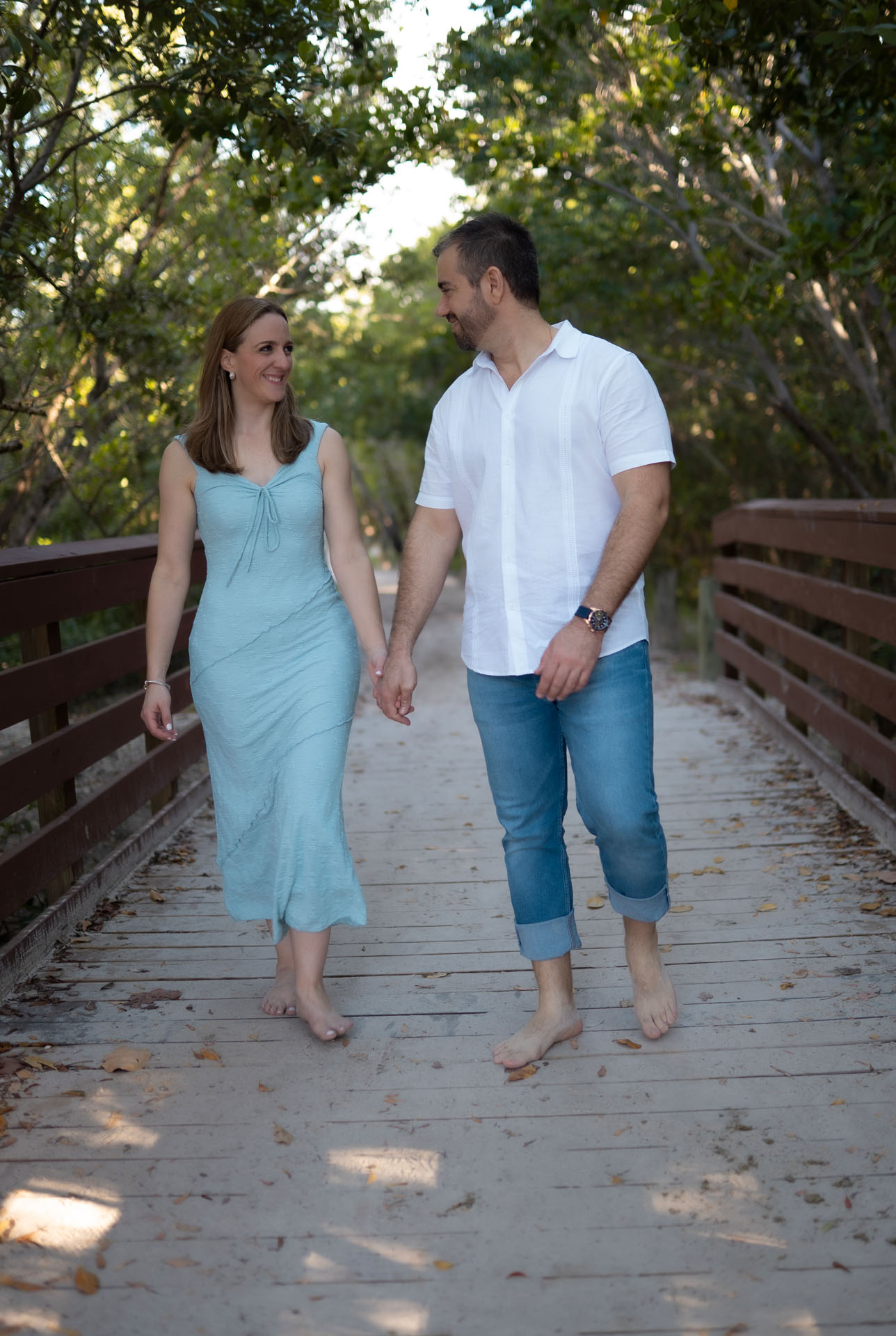Ingrid and Miguel walking across a wooden bridge